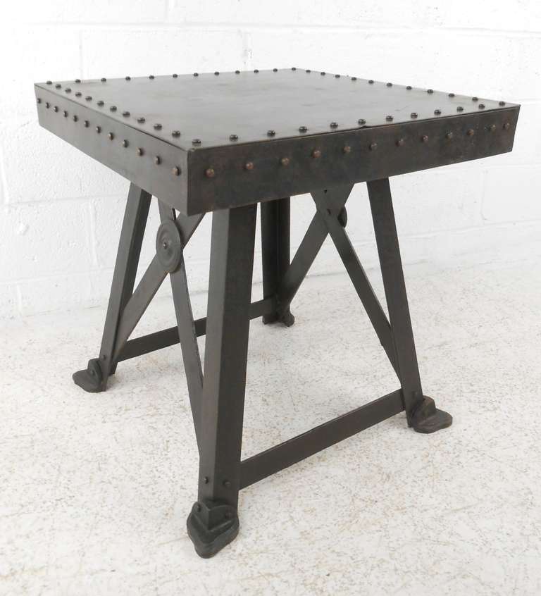 Industrial style construction with exposed rivets, heavy gauge steel and angle iron legs with oversized sabots. Please confirm item location (NY or NJ) with dealer.