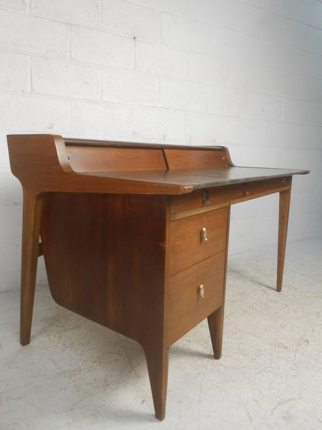 Gorgeous finished back desk with faux leather top and matching chair designed by John Van Koert for Drexel. Great modern design with sliding panel storage, four drawers, silver plated pulls, and a beautiful sculpted back.

(Please confirm item