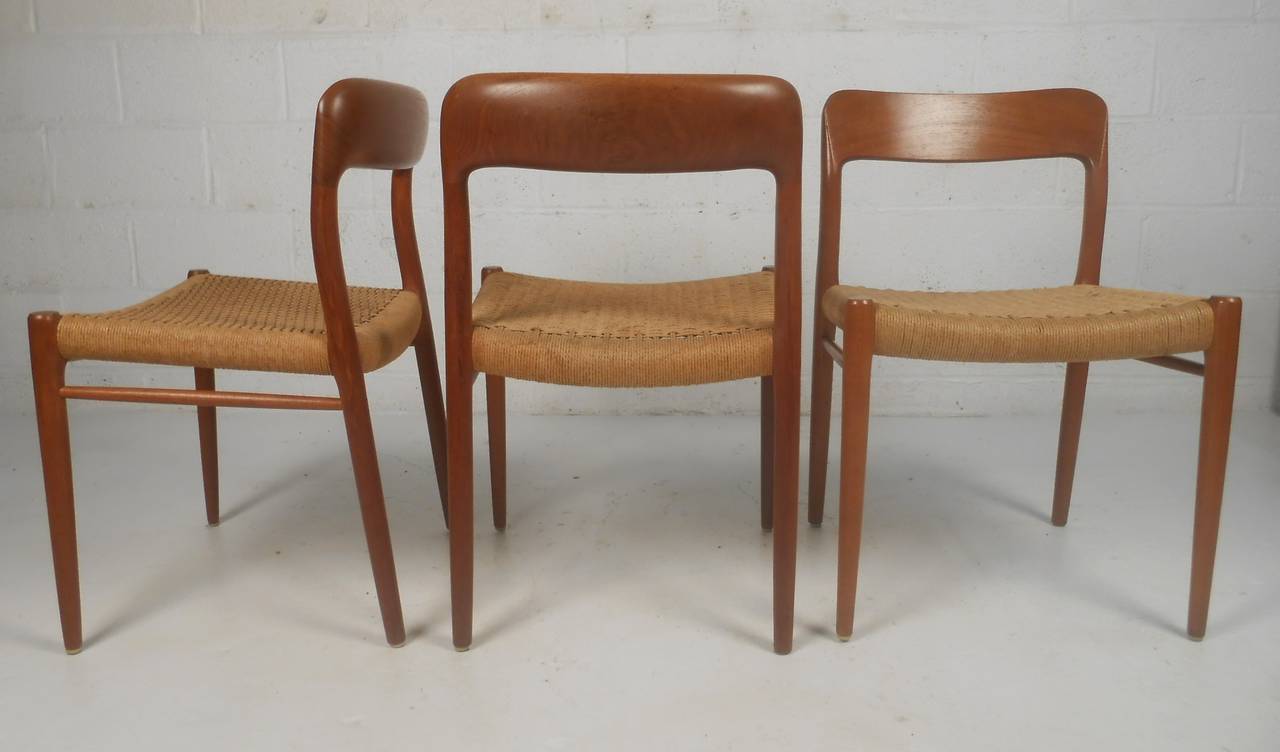 Set of six teak dining chairs with Danish cord seats by N. O. Moller. Danish furniture seal and makers mark. This stylish set boasts a two-tone design with comfortable rush seats, tapered legs, and a curved back rest. and a  Please confirm item