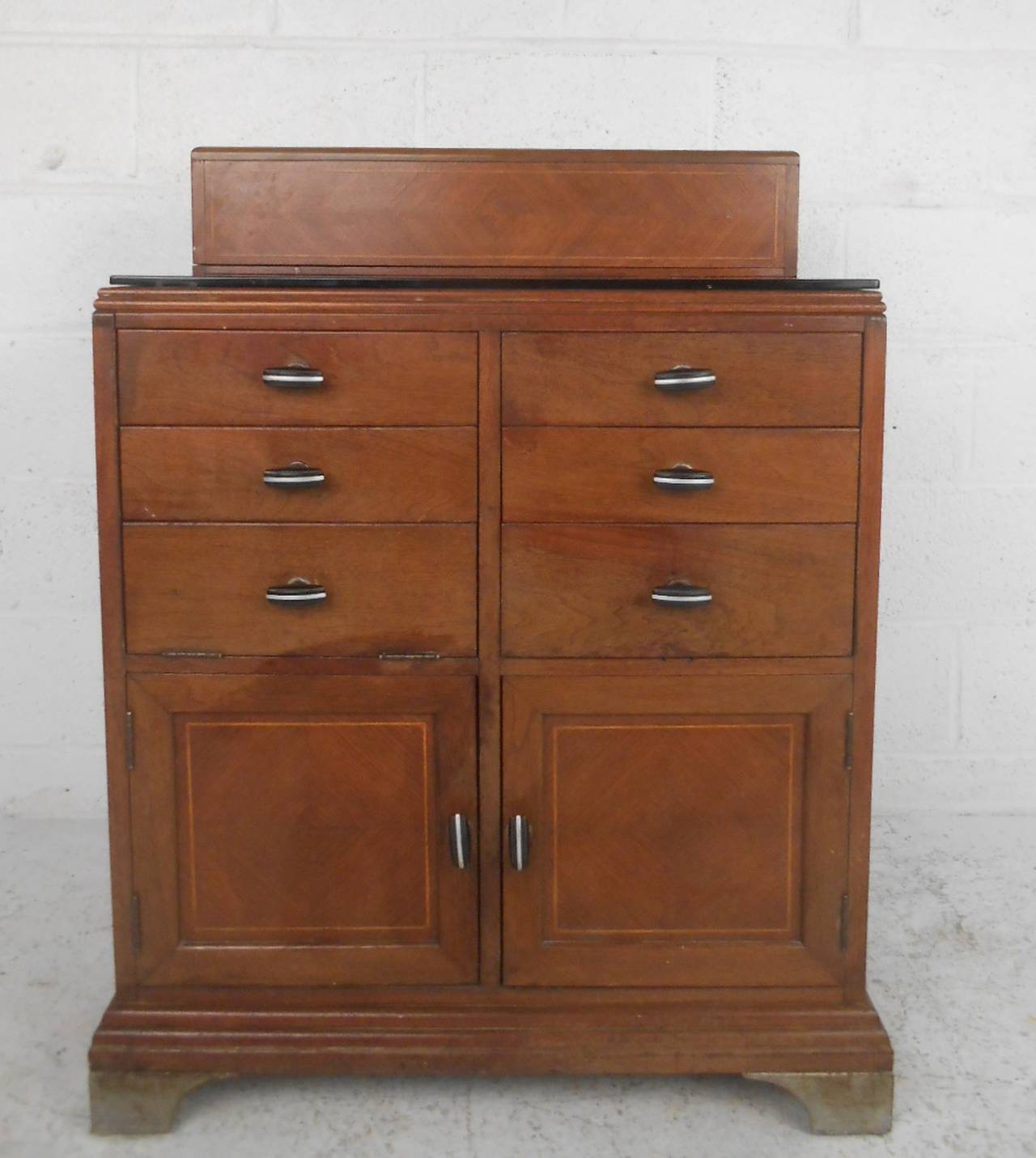 Vintage medical or dental station with diamond grain hinged top, black glass work area, multiple size cabinet space. Lovely detailing to the doors and top, original black handles, made by Charles Lentz & Sons.

(Please confirm item location - NY