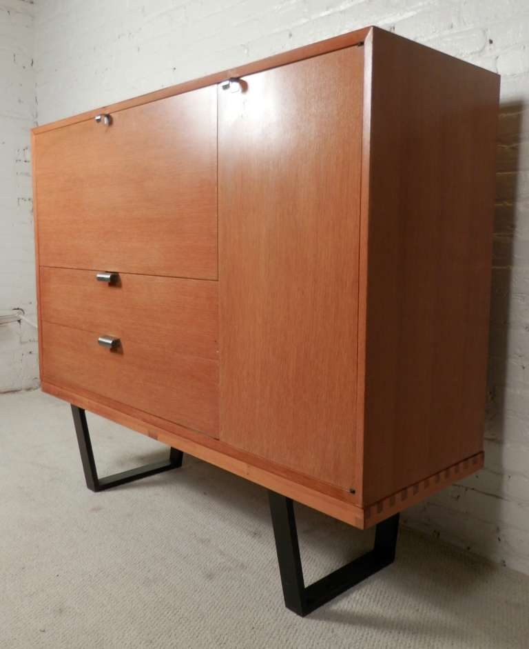 Classic Mid-Century Modern combed oak cabinet with drop front bar. Sits on the famous George Nelson slat bench. Two bottom drawers, side cabinet with shelves. Designer label inside. Slat bench measures 57 W, 19 D, 14 H. (Please confirm item location