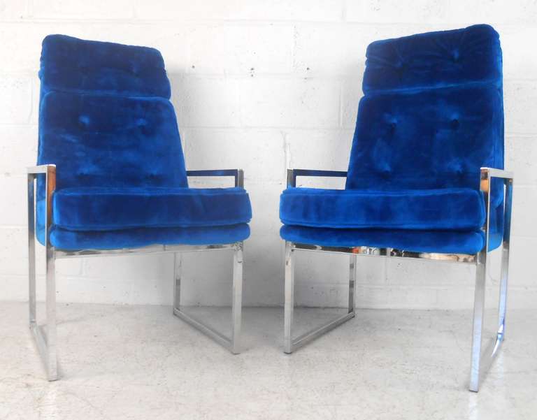 This unique set of six high back chairs by Chromcraft feature dramatic high back seats, blue tufted upholstery, and Milo Baughman style chrome frames. The striking size, color, and comfort of this matching set of dining chairs make a memorable
