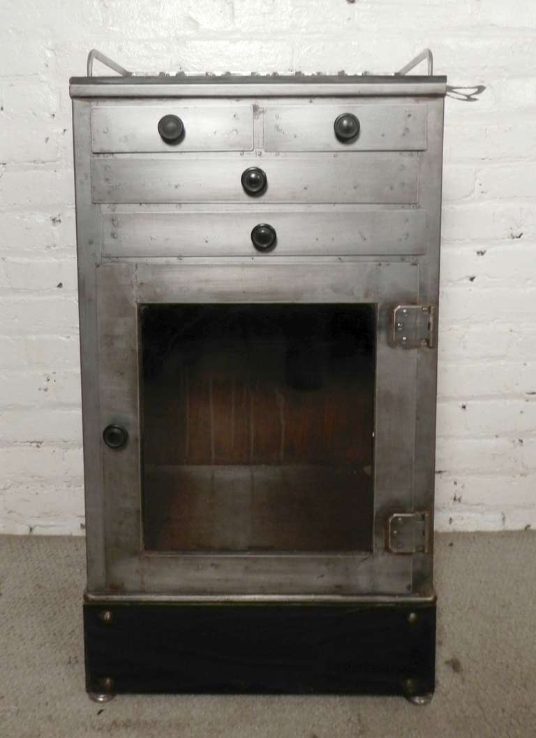 Vintage operating stand with glass door cabinet, newly restored in a striking bare metal finish to accommodate your kitchen or bathroom. Plenty of storage for utencils, cleaning supplies, etc.

(Please confirm item location - NY or NJ - with