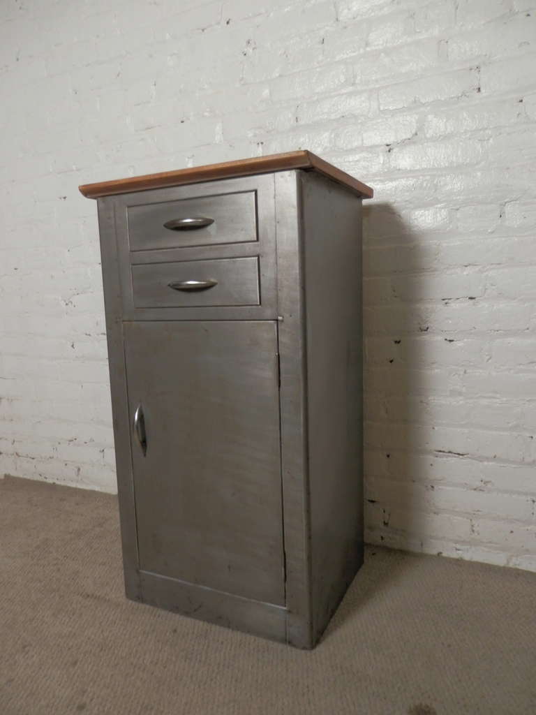 Newly refinished hospital table stripped to bare metal and lacquered for modern use in the home. Ample storage with cabinet and two drawers and finished wood top. Makes a great bathroom cabinet or side table.

(Please confirm item location - NY or