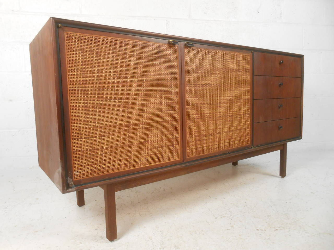 This unique cane front credenza makes a unique server in a tight dining space. Spacious cabinet storage, leather door pulls, and lovely vintage cane set this piece apart from others.  Please confirm item location (NY or NJ).