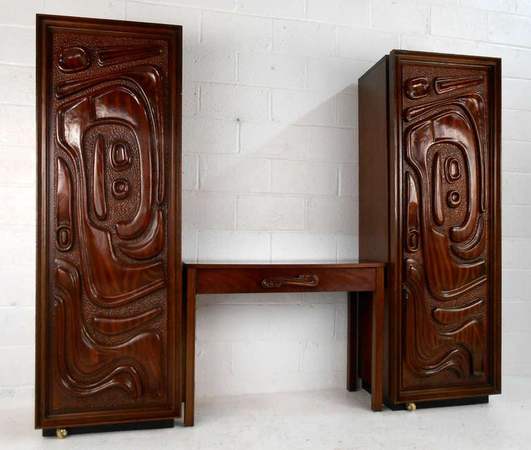 This unique pair of 1960's cabinets in the distinctive style of Phillip Lloyd Powell comes complete with matching writing desk. The beautifully carved front panels create a truly unique and eye-catching addition to any room, perfect way to complete