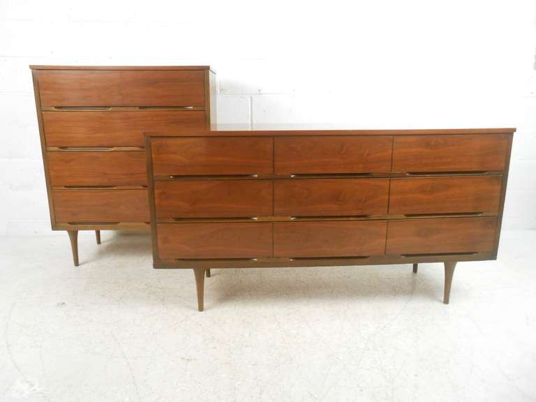 Matching pair of Mid-Century walnut dressers featuring recessed drawer pulls and tapered legs and a sleek, Minimalist appearance. Please confirm item location (NY or NJ) with dealer.

Highboy measures: 34.5 W x 18 D 42 x H
Low long dresser