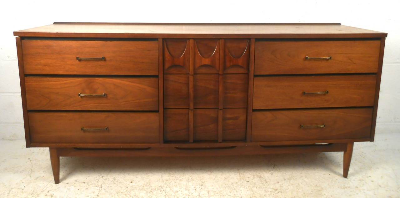 This attractive nine-drawer dresser features a rich two tone finish with sculpted drawer fronts, similar to mid-century Broyhill Brasilia or Kent Coffey's Perspecta style. Please confirm item location (NY or NJ) with dealer.