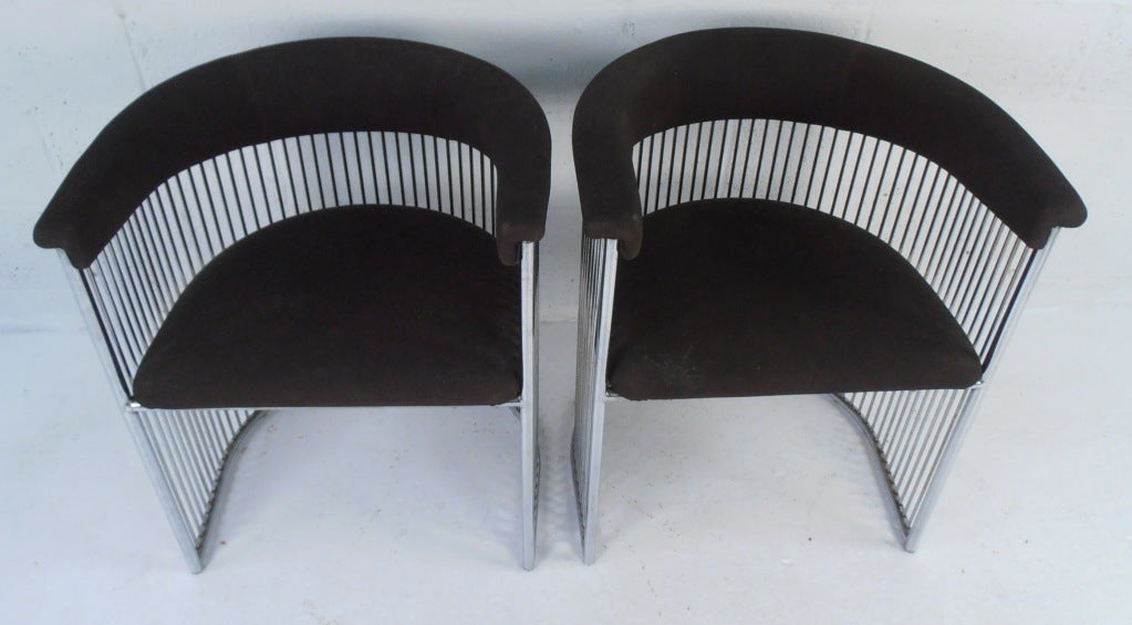 Dramatic chrome-ribbed barrel back side chairs.