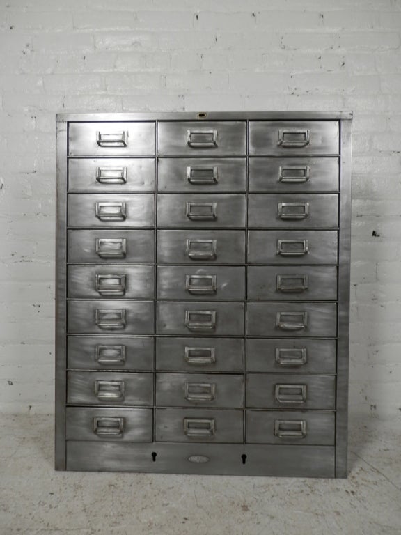 Beautifully stripped metal file cabinet for many storage uses.