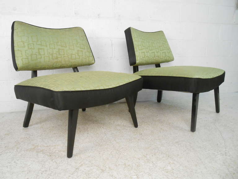 Vintage easy chairs with floating seats and tapered legs bring stylish modern design to home or business seating. Vintage fabric and black lacquered frame. Please confirm item location (NY or NJ) with dealer.
