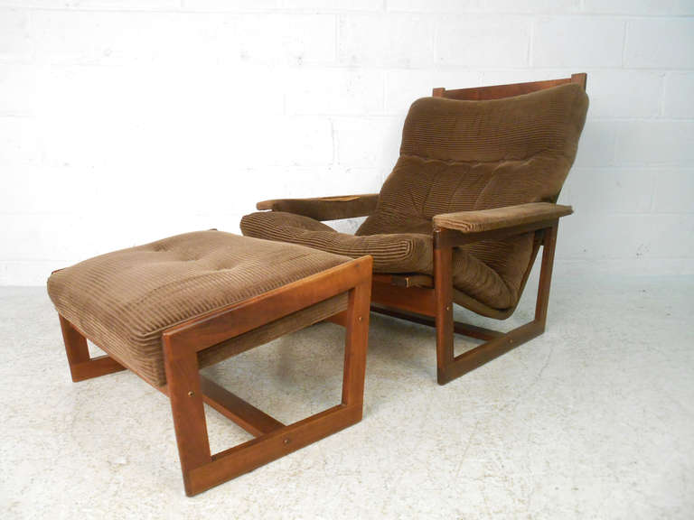 This stylish midcentury American lounge chair and ottoman have solid walnut frames with comfortable upholstered cushions. Please confirm item location (NY or NJ) with dealer.