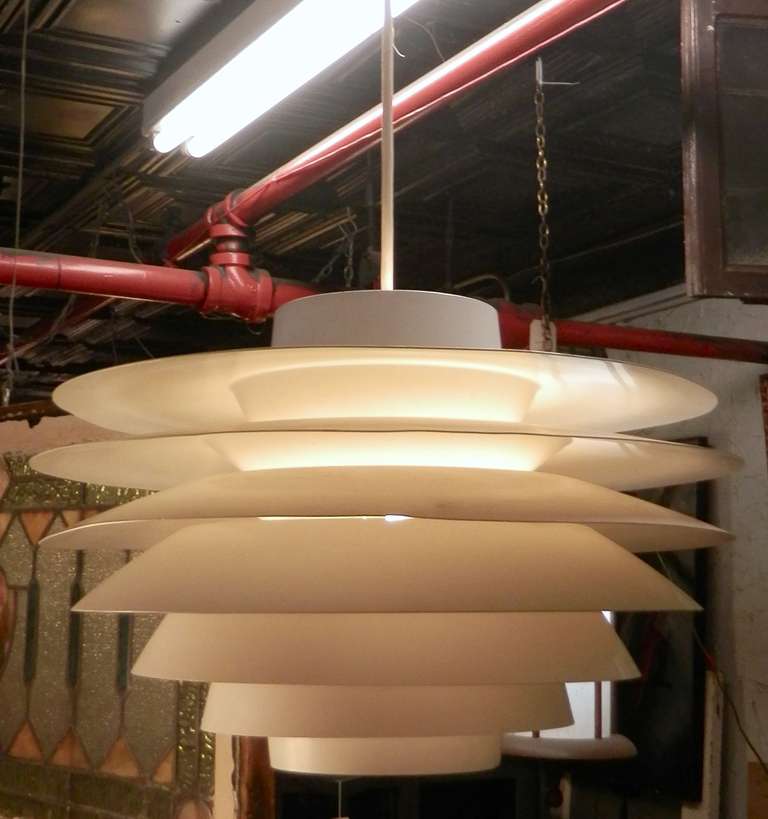 Designed by Sven Middleboe for Nordisk Solar, this strikingly sculptural lamp uses seven curved rings to help diffuse the light in a glare-free, even white glow. Designed in a similar style to that of famed architect/designer Poul
