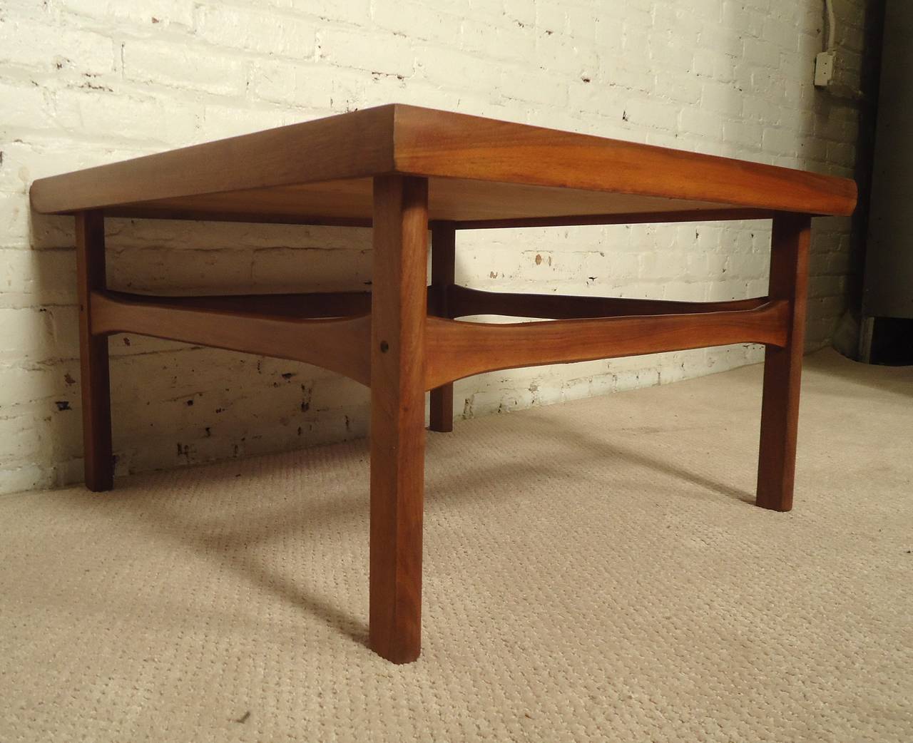Vintage modern Danish table with simple lines and nicely turned edge. Attractive wood grain, sculpted stretchers.

(Please confirm item location - NY or NJ - with dealer)