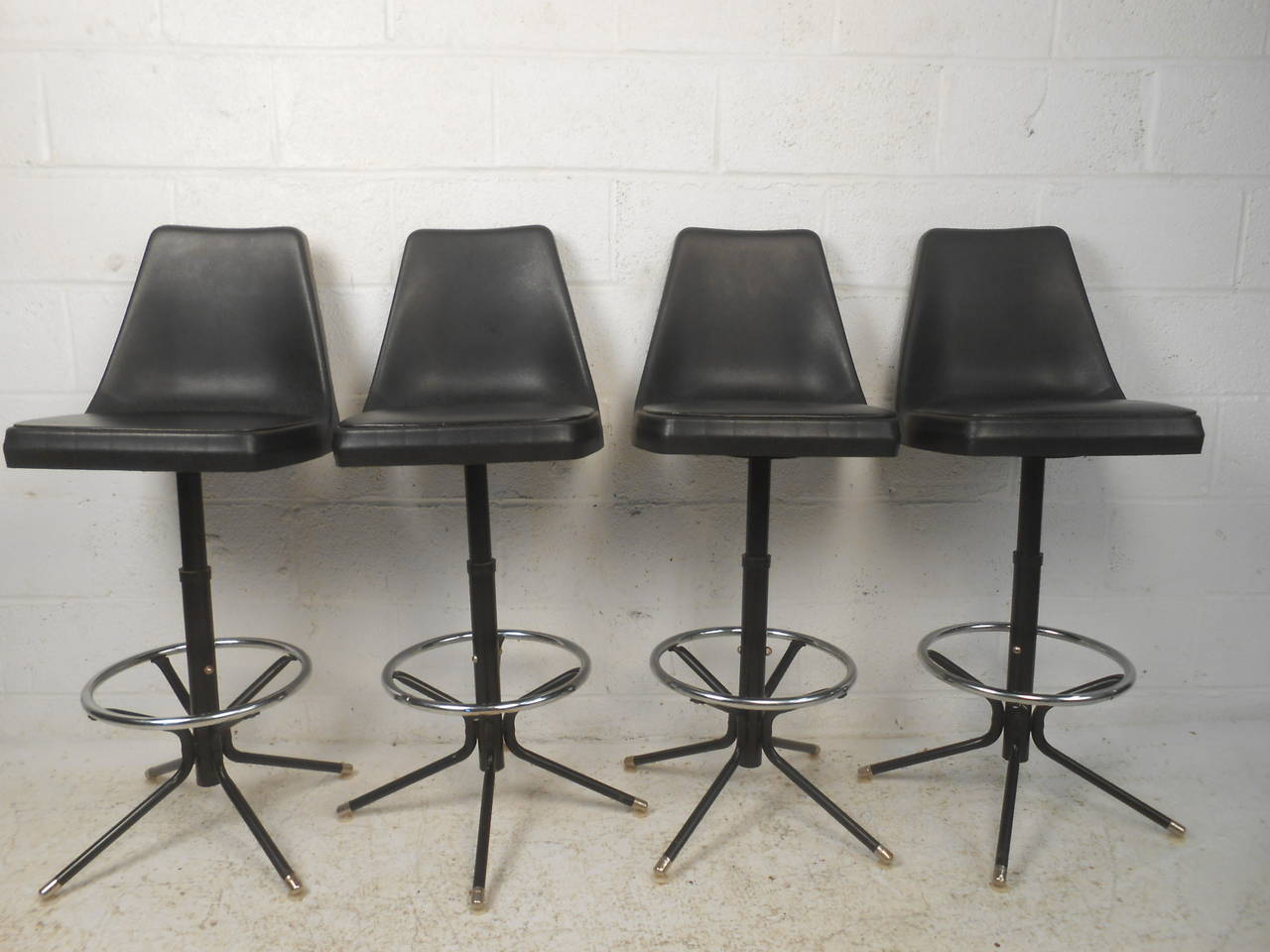 Vintage modern stools with plastic backs and vinyl seats. Chrome foot rests, swivel seats, attractive curved back.

(Please confirm item location - NY or NJ - with dealer)