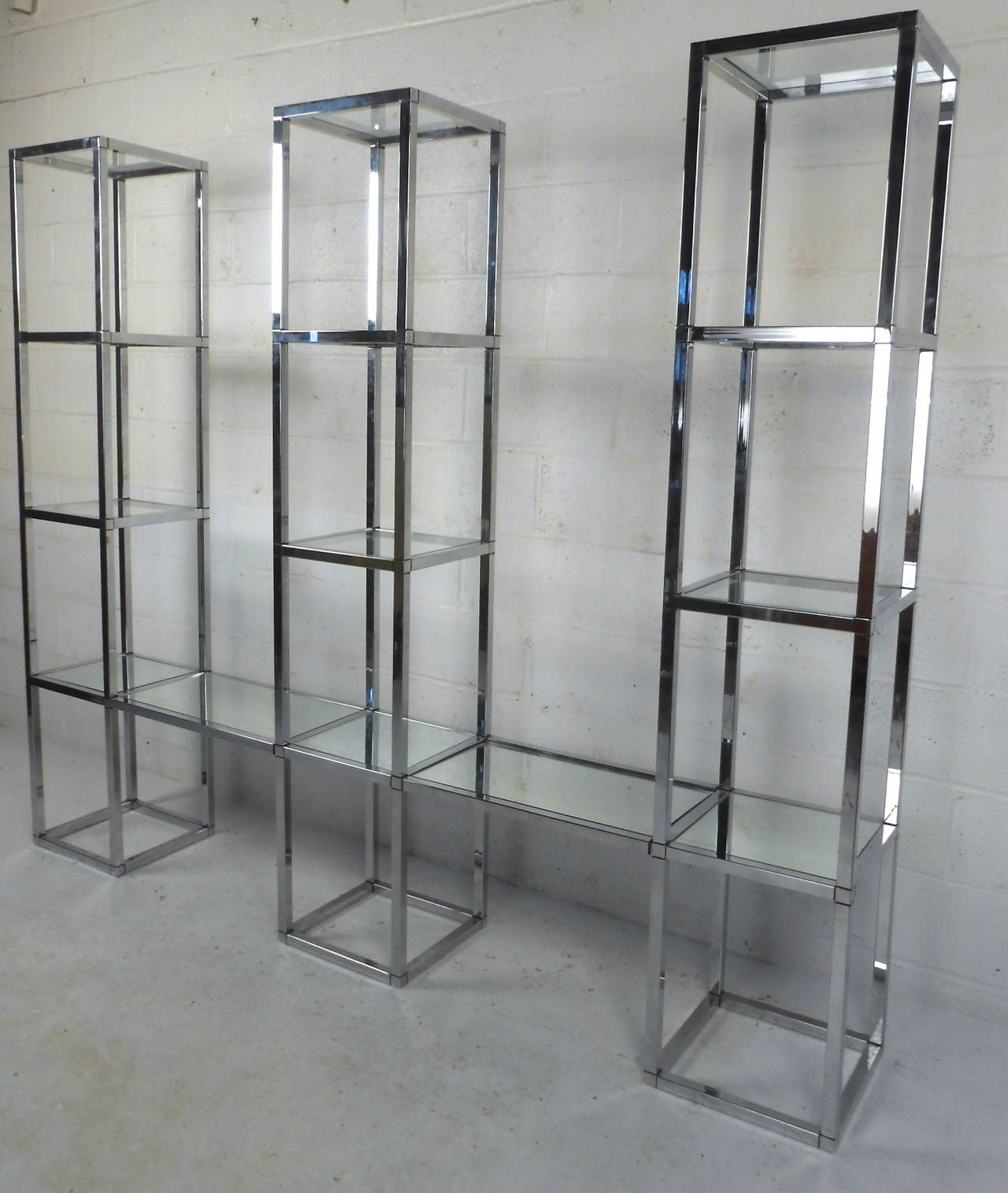 This Baughman style étagère is made of three heavy chrome towers connected by mirrored floating shelves. Wonderful wall display for home or shop, please confirm item location (NY or NJ).