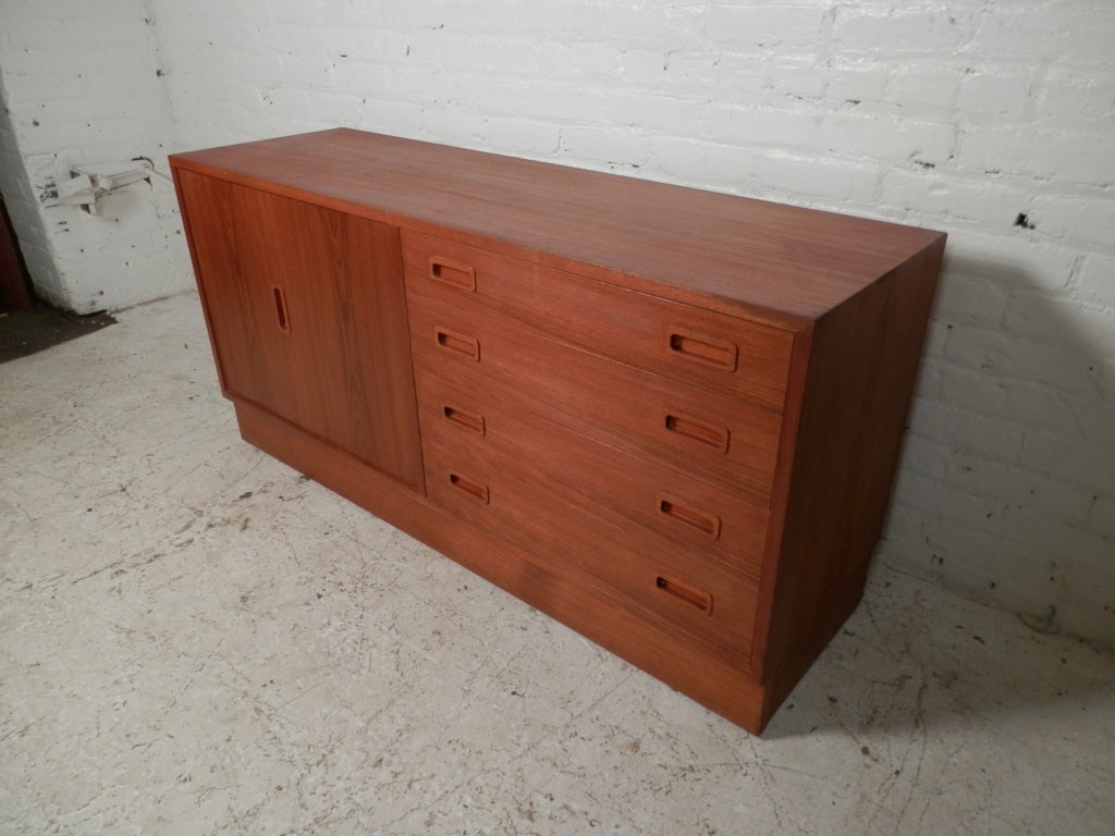 Classic Danish modern style dresser with side door and adjustable shelves.