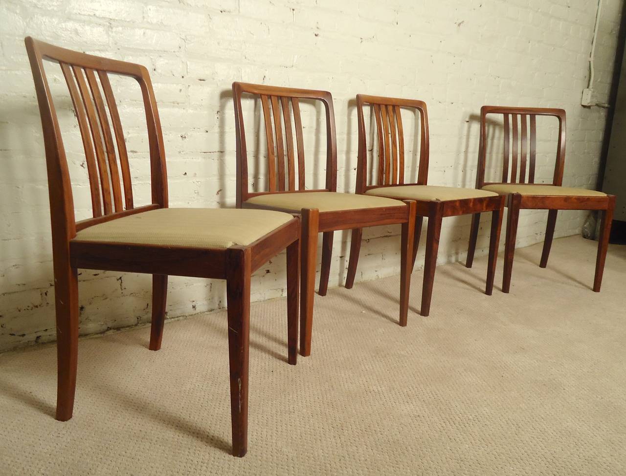 Mid-century modern Danish dining chairs with striking rosewood frame. Slat backs, easily reupholstered. 

(Please confirm item location - NY or NJ - with dealer)