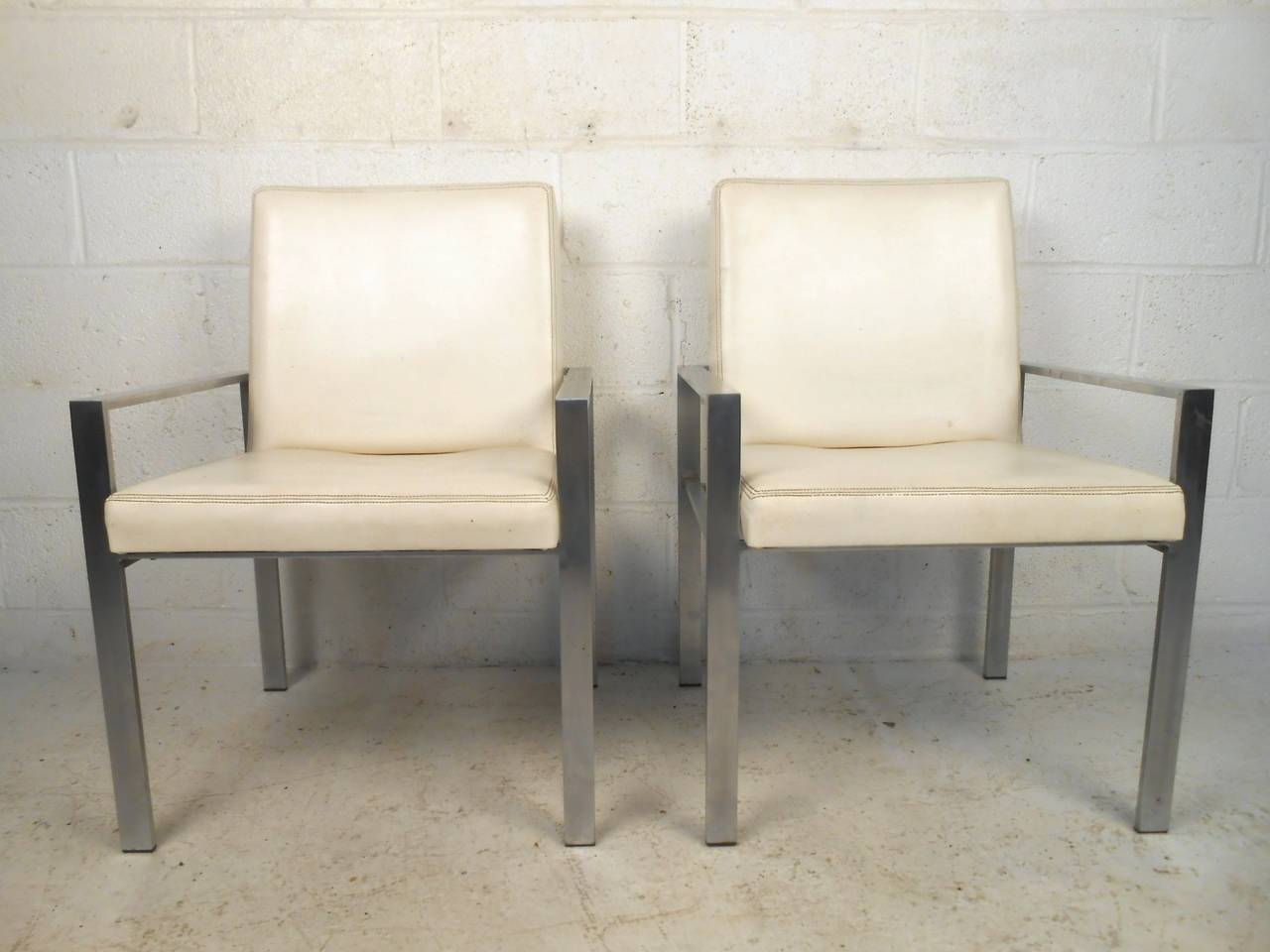 This set of four dining chairs features sturdy aluminum frames, vintage leather upholstery, and comfortable design. Unique set for any modern conference or dining room table. Please confirm item location (NY or NJ).