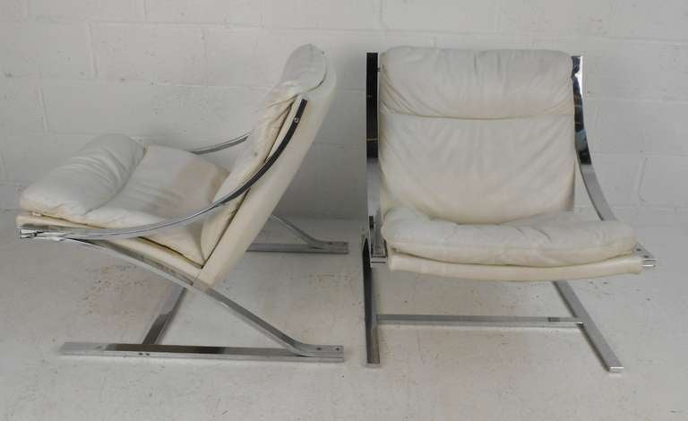 Pair of white leather lounge chairs designed by Paul Tuttle and made by Strassle International. Please confirm item location (NY or NJ) with dealer.