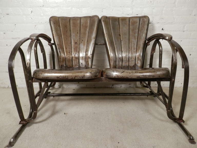 industrial metal two seat glider with unusual arched arms. Super comfortable. The glider has been stripped and sanded, then lacquered for a striking industrial look.

(Please confirm item location - NY or NJ - with dealer)