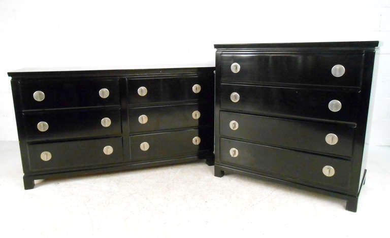 This vintage pair of black lacquer dressers feature unique design and spacious drawers. Circular metallic drawer pulls make this a stylish storage options for any room. Please confirm item location (NY or NJ).

Measures: Highboy measurements: 40