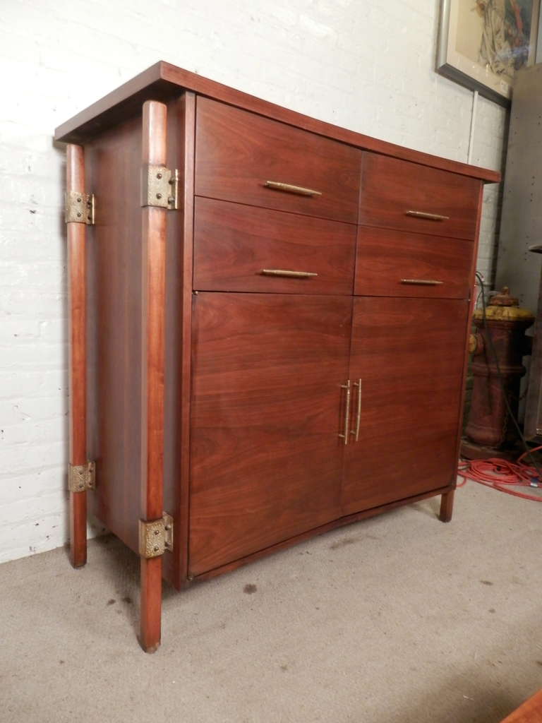 Exquisite dresser by Romweber, designed with solid walnut, hammered brass hardware and a curved bow-tie body. Extremely unique size and shape, hefty and well built.

(Please confirm item location - NY or NJ - with dealer).