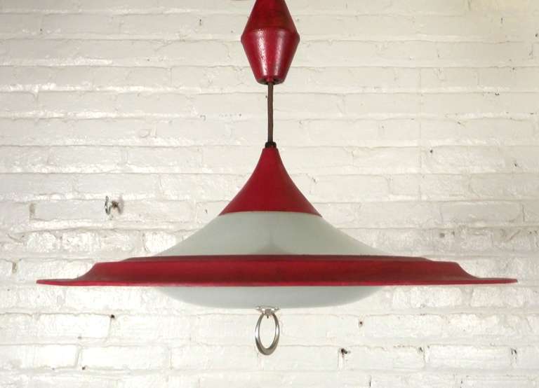 Super 1960s saucer shape hanging lamp with red iron ring around two opaque glass lids. Atomic Era style with a nod to the UFO fascination of the mid-196s.

(Please confirm item location NY or NJ with dealer).