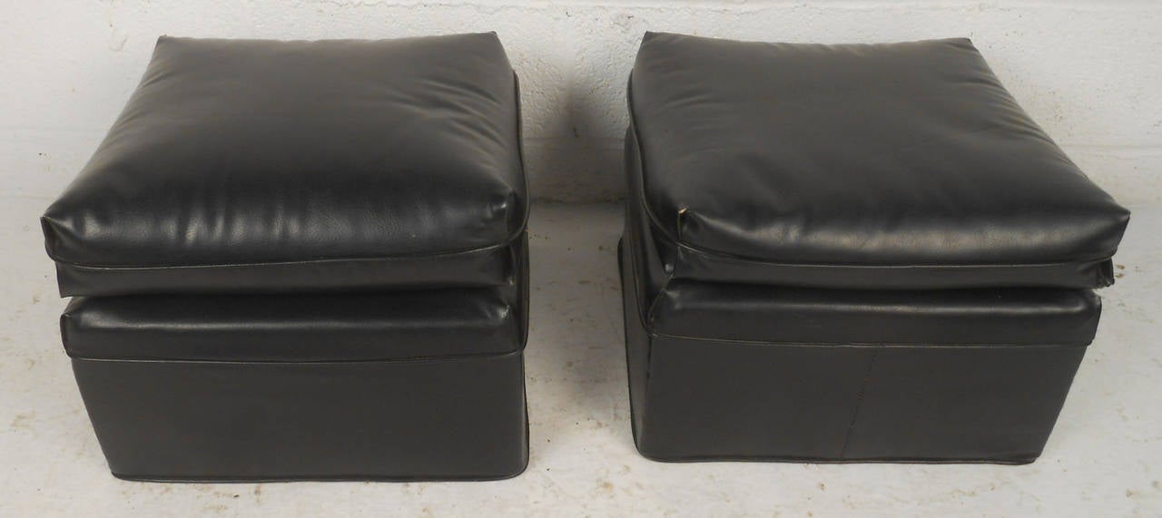 Two comfortable vintage-modern black vinyl ottomans.

(Please confirm item location - NY or NJ - with dealer)