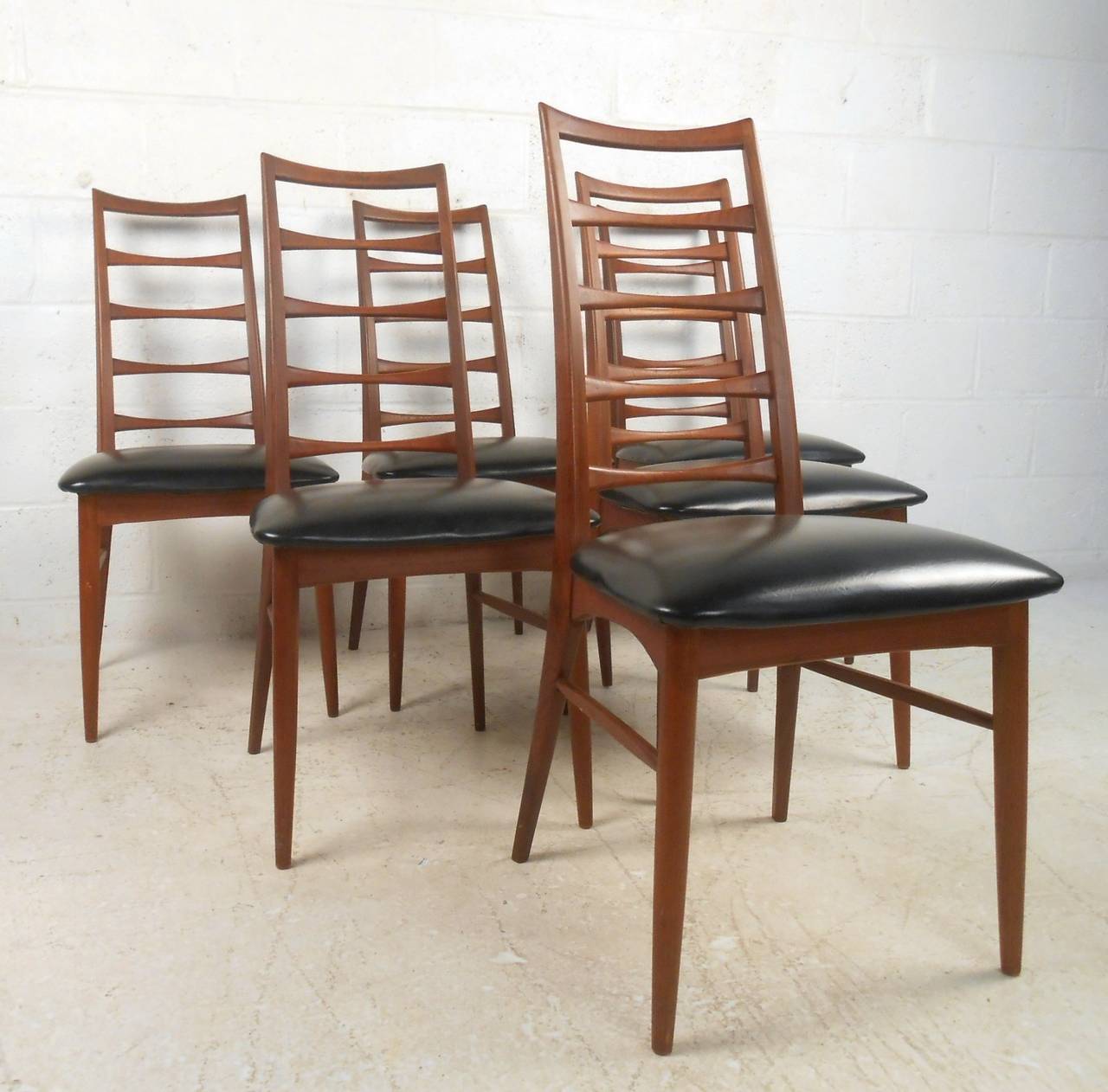 This set of six vintage ladder back chairs make for a beautiful addition to any setting. Manufactured in Denmark for Raymor, the uniquely tapered ladder backs, tapered legs, and stylish design make this teak set truly unique. Please confirm item