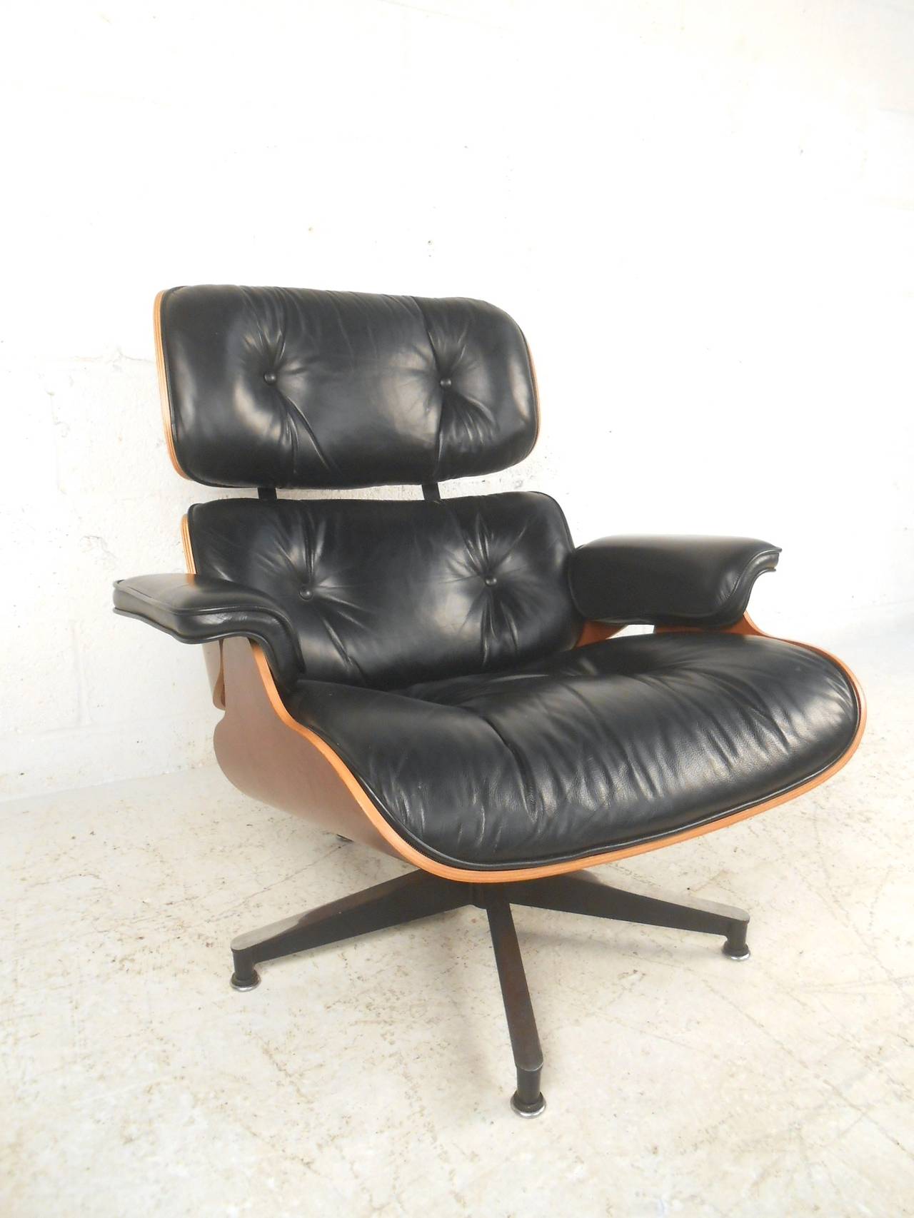 This modern Herman Miller swivel chair with ottoman makes for the ultimate mix of vintage style and comfort for any room. Original manufacturers tags are on this contemporary edition of their Classic design. Please confirm item location (NY or NJ).