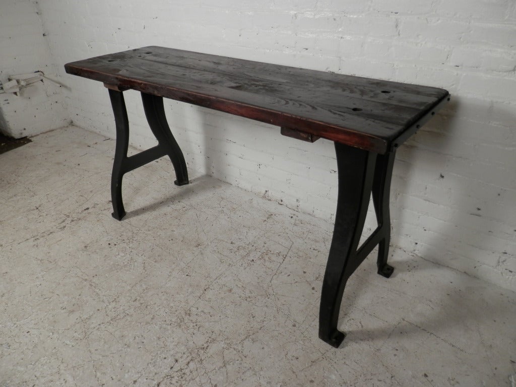 Very old industrial style work table with original base and top.