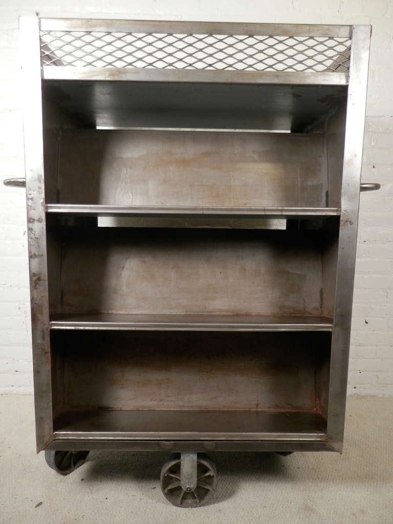 Heavy duty metal cart on over-sized casters. Once used in factories, can now be used as a rolling pantry or bookcase.

(Please confirm item location - NY or NJ - with dealer)