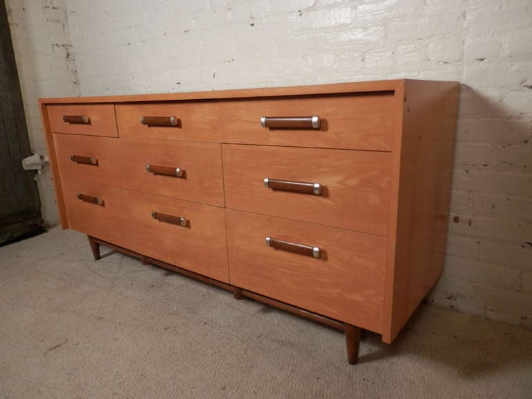 Unique set of vintage modern bedroom furniture designed by Merton L. Gershun for Martinsville. Devoid of his usual louvered front, instead these pieces have clean, straight lines, made of nice blonde maple with walnut handles. Long nine drawer