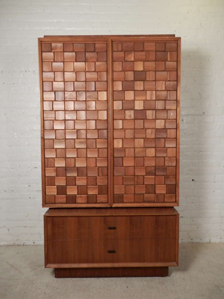 Paul Evan's style tall armoire with great patchwork pattern. This is a two piece unit, with the large cabinet resting on a two drawer base. Similar to the very sought after 