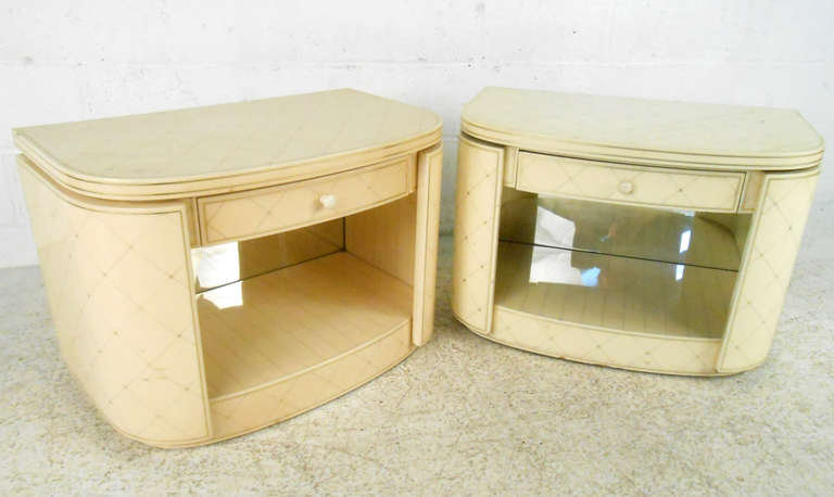 This unique and stylish pair of vintage bedside tables feature a decorative lacquer finish, with unique detailed inlay, mirrored backs, and plenty of space for storage. Ideal for use as lamp tables or nightstands, this Mid-Century pair make a