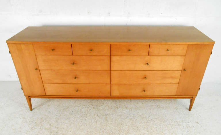 This unique 20 drawer dresser by Paul McCobb features the Classic drawer pulls and maple finish that made this Mid-Century Furniture line so popular. Piece is stamped 