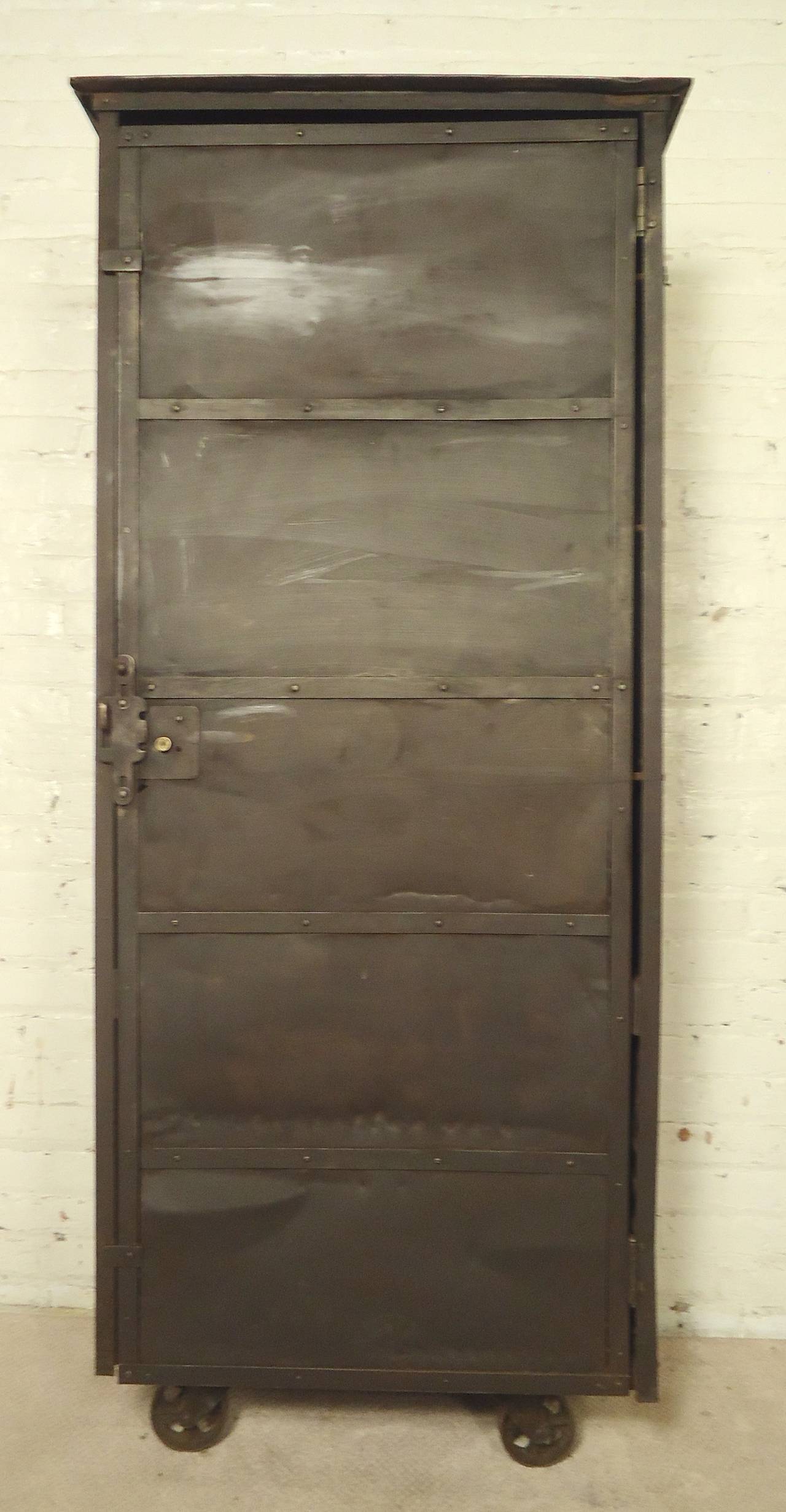 Unusual tall cabinet with industrial factory style. Set on large casters, substantial cabinet space, latching door.

(Please confirm item location - NY or NJ - with dealer)
