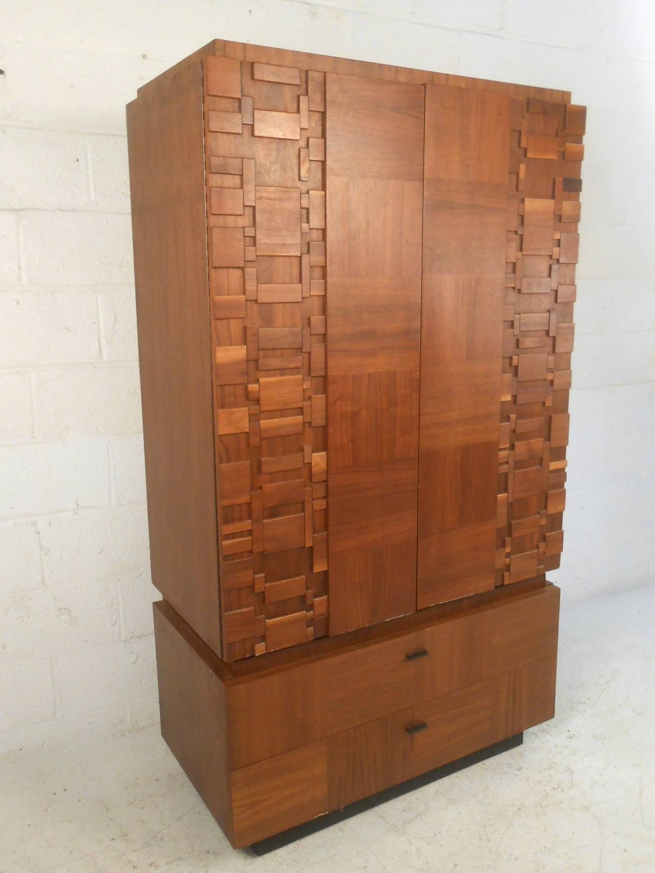 This gorgeous vintage armoire by Lane combines brutalist style details with a multi-veneer face to make a stylish storage piece for any interior. Please confirm item location (NY or NJ), match bedroom set available.
