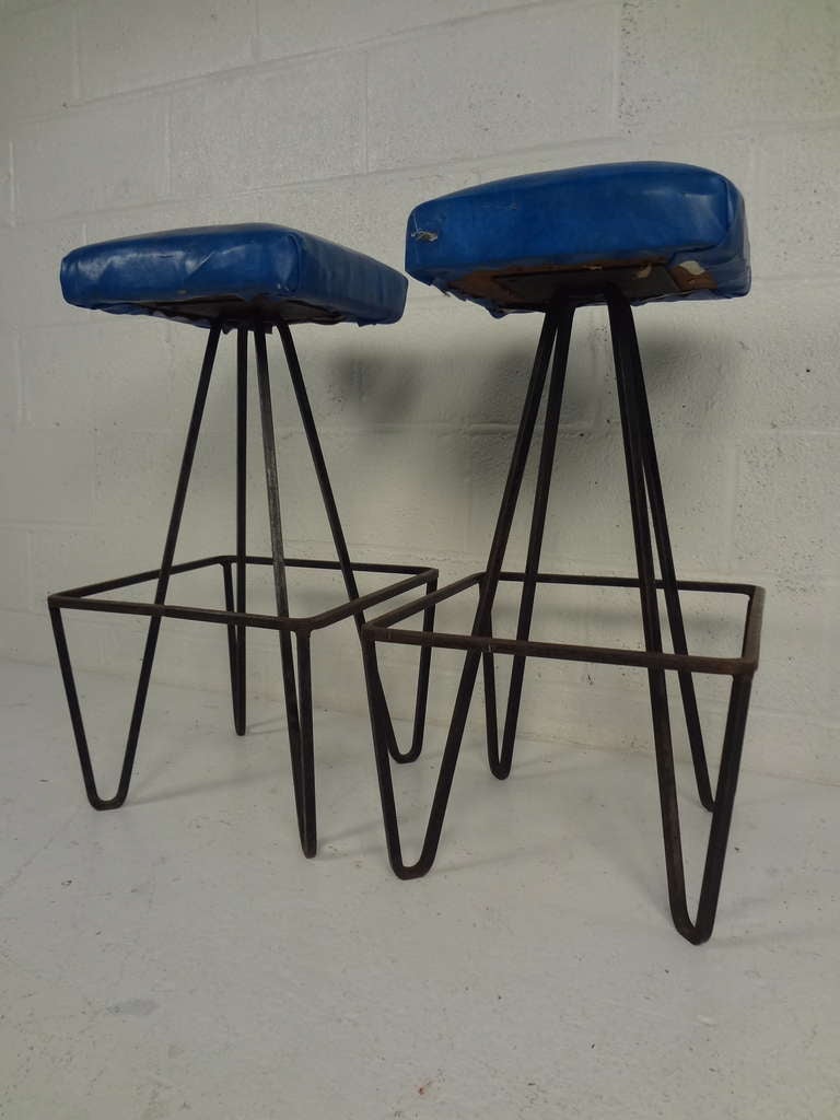 Pair of Weinberg hairpin leg stools with 360 degree wrought iron footrests. Please confirm item location (NY or NJ) with dealer.