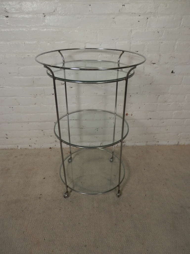 This is a three tier chrome and plate glass martini cart with small castor wheels. All three levels give you plenty of room for shakers, glasses, bottles and the wheels make it easy to serve your guests. Also can be used as a side table.

Please