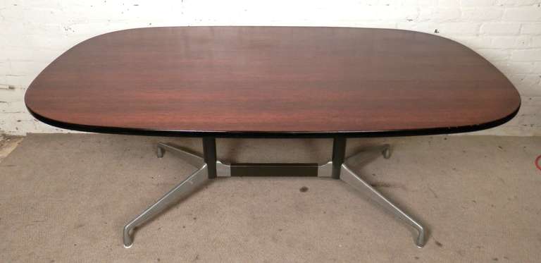 Charles and Ray Eames designed this conference table for Herman Miller's Aluminum Group Office line. Featuring a large oval ash wood top set on a sturdy aluminum base. Original label is still on the underside.

(Please confirm item location - NY