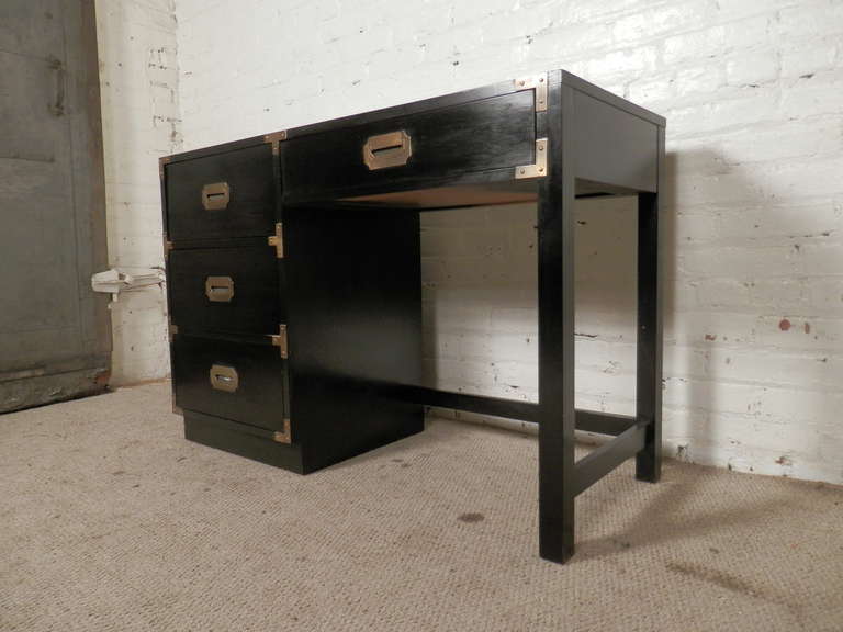 Attractive campaign style desk in black lacquer finish. Accenting brass hardware works well off the black finish. The back is also black, so this can work in any space.

Kneehole: 23w 17d 23h

(Please confirm item location - NY or NJ - with