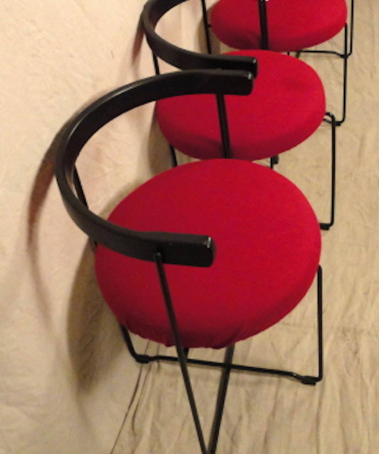 Unusual round back chairs with black wood back, matching iron base and vibrant red seats. Simple shape and style for home or office.

(Please confirm item location - NY or NJ - with dealer)