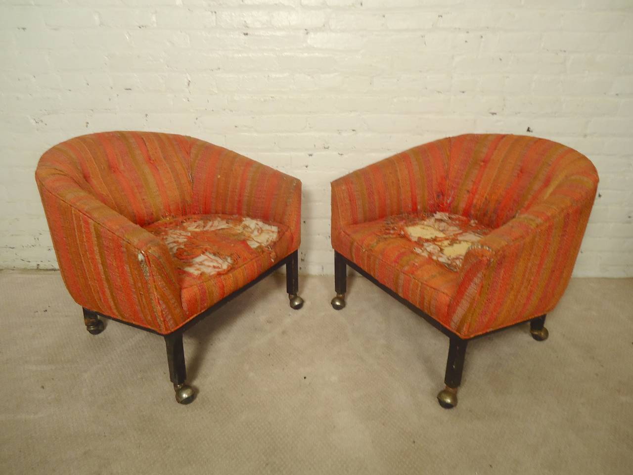Elegant pair of vintage modern round back chairs on casters. Once recovered these will serve as beautiful lounge chairs with a black wood base.

(Please confirm item location - NY or NJ - with dealer)