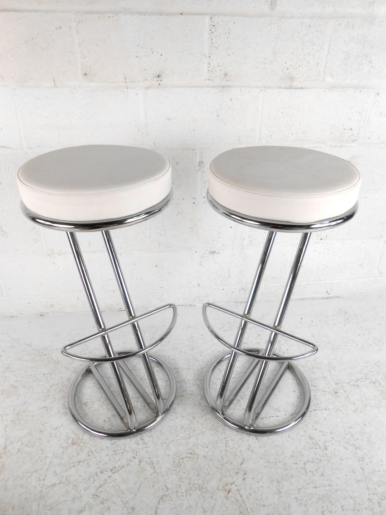 This pair of midcentury bar stools feature beautiful white vinyl upholstery and modern chrome bases which offer comfortable seating and a unique flare to any home or office space.  

Please confirm item location (NY or NJ) with dealer.
