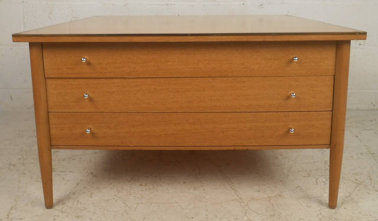 Unique three-drawer table from the Connoisseur collection of Paul McCobb. Drawers have chrome pulls and top has brass accent detail. Please confirm item location (NY or NJ) with dealer.