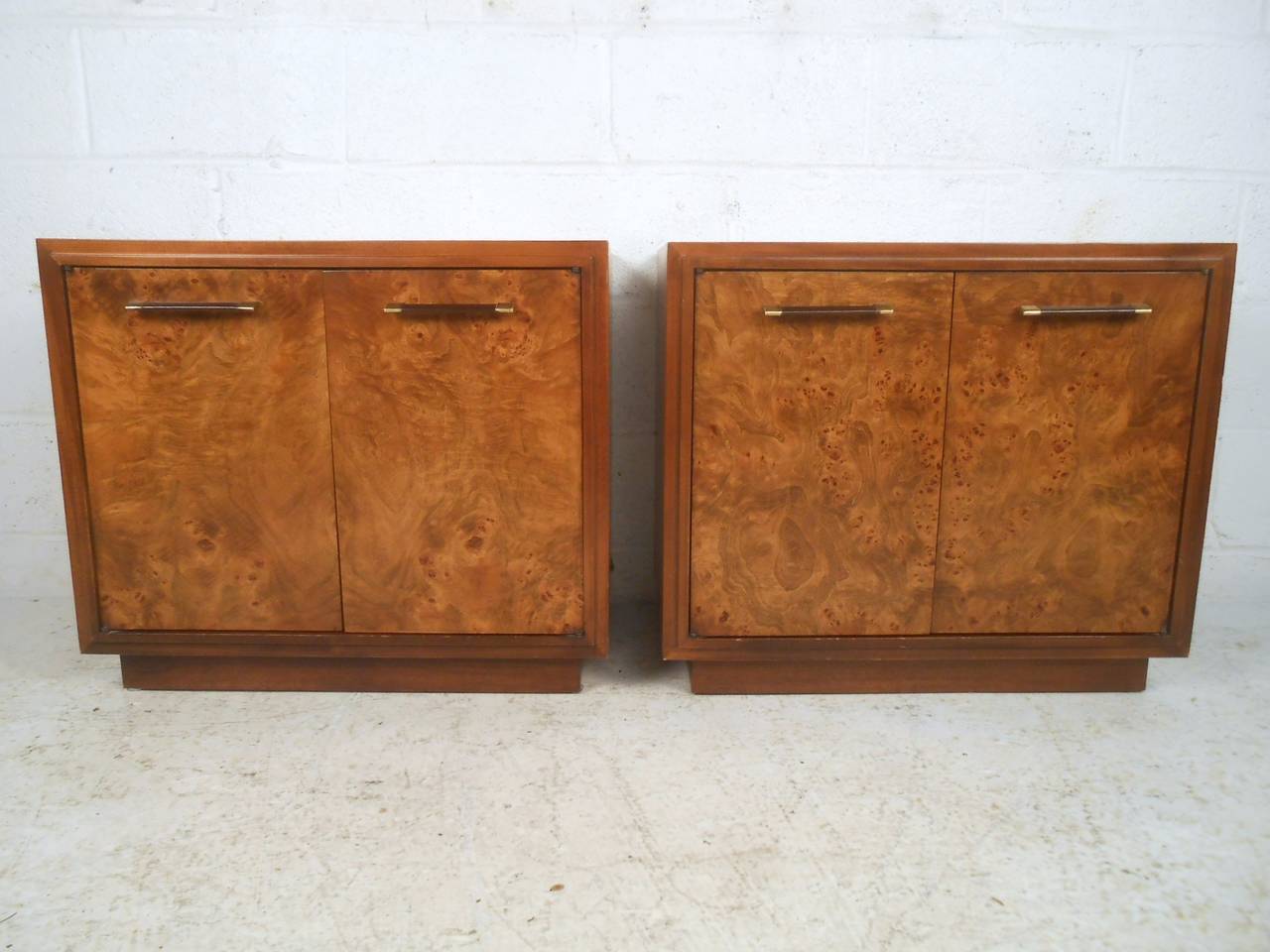 This matching pair of vintage nightstands features a lovely burl wood veneer, leather and brass door pulls, and plenty of cabinet storage for any interior. Matching highboy and dresser available, please confirm item location (NY or NJ).