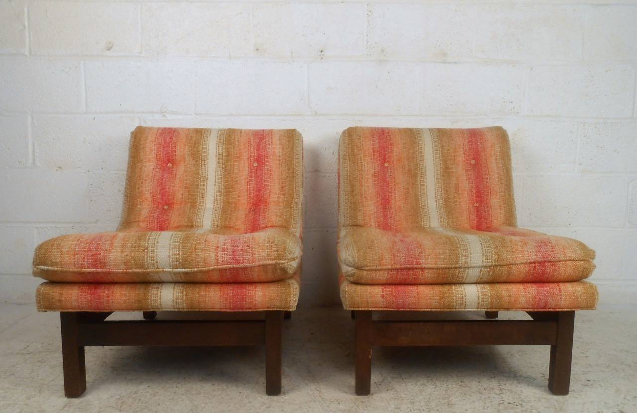 This pair of Wormley style slipper chairs feature unique Dunbar style design, tufted upholstery, and unique vintage fabric. An overstuffed cushion and a sturdy walnut base provides maximum comfort without sacrificing style. Wonderful matching pair