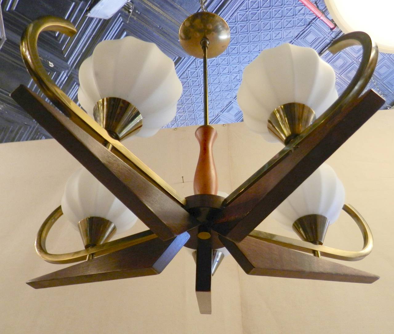 Five arm chandelier featuring brass arms, walnut accents and milk white glass globes. Long thin stem to ceiling mount. Attractive lighting for dining room or entry way.

(Please confirm item location - NY or NJ - with dealer)